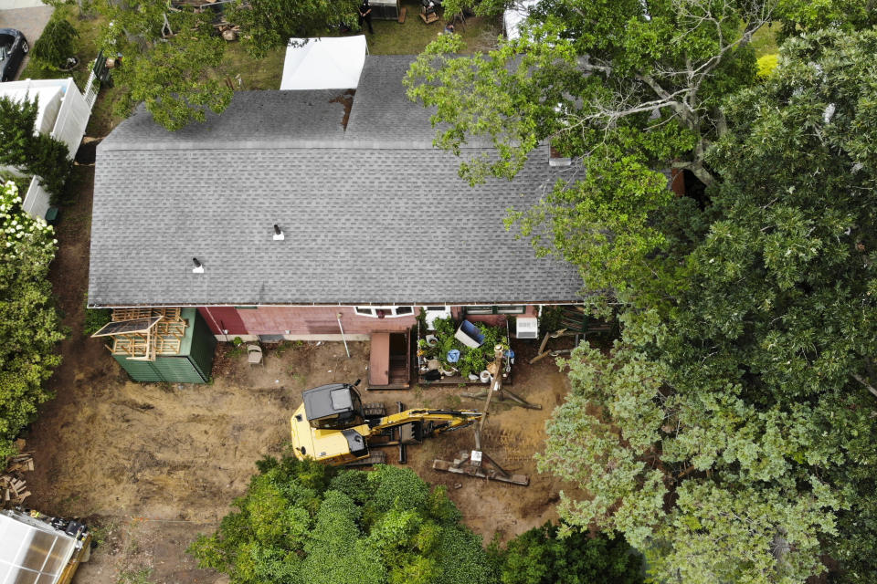 Authorities continue to work at the home of suspect Rex Heuermann in Massapequa Park, N.Y., Monday, July 24, 2023. Heuermann has been charged with killing at least three women in the long-unsolved slayings known as the Gilgo Beach killings. (AP Photo/Seth Wenig)