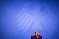 CORRECTS DAY - German Chancellor Angela Merkel attends a news conference with Bavarian state governor Markus Soeder and the Mayor of Berlin Michael Mueller after a meeting at the chancellery in Berlin, Germany, Wednesday, March 3, 2021. German Chancellor Angela Merkel conferred with the governors of the country's 16 states to discuss how to move forward with coronavirus restrictions (AP Photo/Markus Schreiber, Pool)