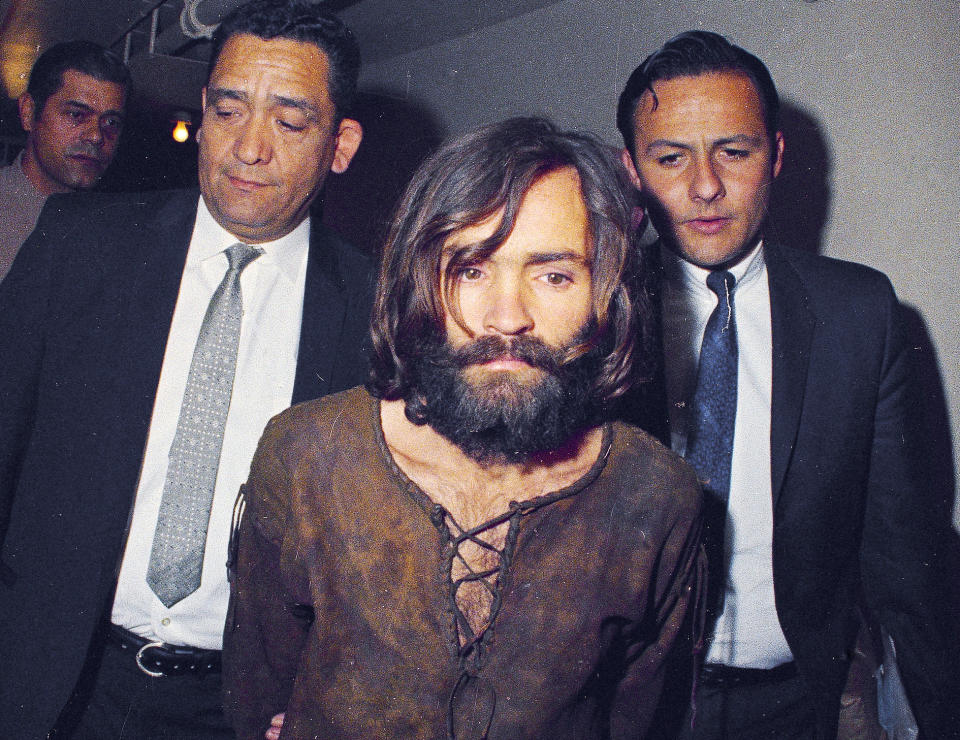 FILE - In this 1969 file photo, Charles Manson is escorted to his arraignment on conspiracy-murder charges in connection with the Sharon Tate murder case in Los Angeles. Fifty years ago Charles Manson dispatched a group of disaffected young hippie followers on a two-night killing spree that terrorized Los Angeles and in the years since has come to represent the face of evil. On successive nights in August 1969, the so-called Manson family murdered seven people. (AP Photo/File)