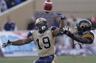 Winnipeg Blue Bombers' Chris Garrett (19) bobbles a pass as Hamilton Tiger-Cats' Renauld Willams (9) moves in during the first half of their pre-season CFL game in Winnipeg Wednesday, June 20, 2012. THE CANADIAN PRESS/John Woods