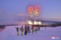 In this Monday, Dec. 2, 2019, photo provided Tuesday, Dec. 3, 2019, by the North Korean government, skiers watch fireworks exploding to mark the completion of Samjiyon city. On Monday, Kim Jong Un visited Samjiyon county at the foot of Mount Paektu to attend a ceremony marking the completion of work that has transformed the town to “an epitome of modern civilization,” KCNA said. It said the town has a museum on the Kim family, a ski slope, cultural centers, a school, a hospital and factories. Independent journalists were not given access to cover the event depicted in this image distributed by the North Korean government. The content of this image is as provided and cannot be independently verified. Korean language watermark on image as provided by source reads: "KCNA" which is the abbreviation for Korean Central News Agency. (Korean Central News Agency/Korea News Service via AP)