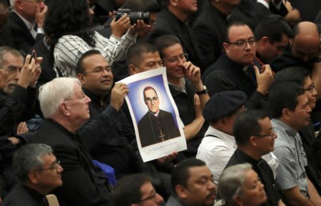 Pilgrims from El Salvador hold the portrait of saint Oscar Romero during the special audience with Pope Francis at Paul VI Hall at the Vatican, October 15, 2018. REUTERS/Tony Gentile