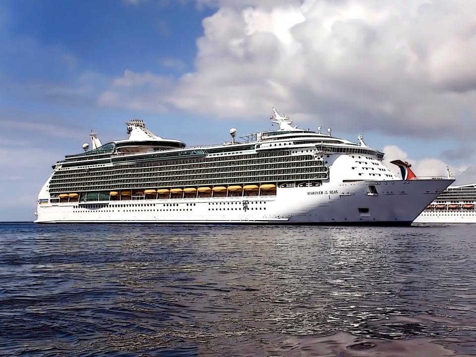 Royal Caribbean's Mariner of the Sea and a Carnival Cruise ship anchored off the shore of Grand Cayman Island.