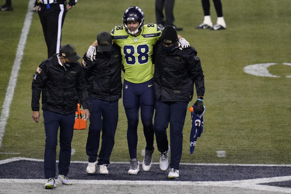 Seattle Seahawks tight end Greg Olsen (88) leaves the field with an injury during the second half of an NFL football game against the Arizona Cardinals, Thursday, Nov. 19, 2020, in Seattle. (AP Photo/Elaine Thompson)