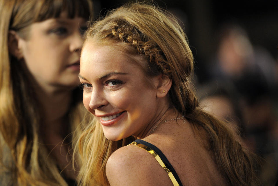 Lindsay Lohan, a cast member in "Scary Movie V," turns back for photographers at the Los Angeles premiere of the film at the Cinerama Dome on Thursday, April 11, 2013 in Los Angeles. (Photo by Chris Pizzello/Invision/AP)