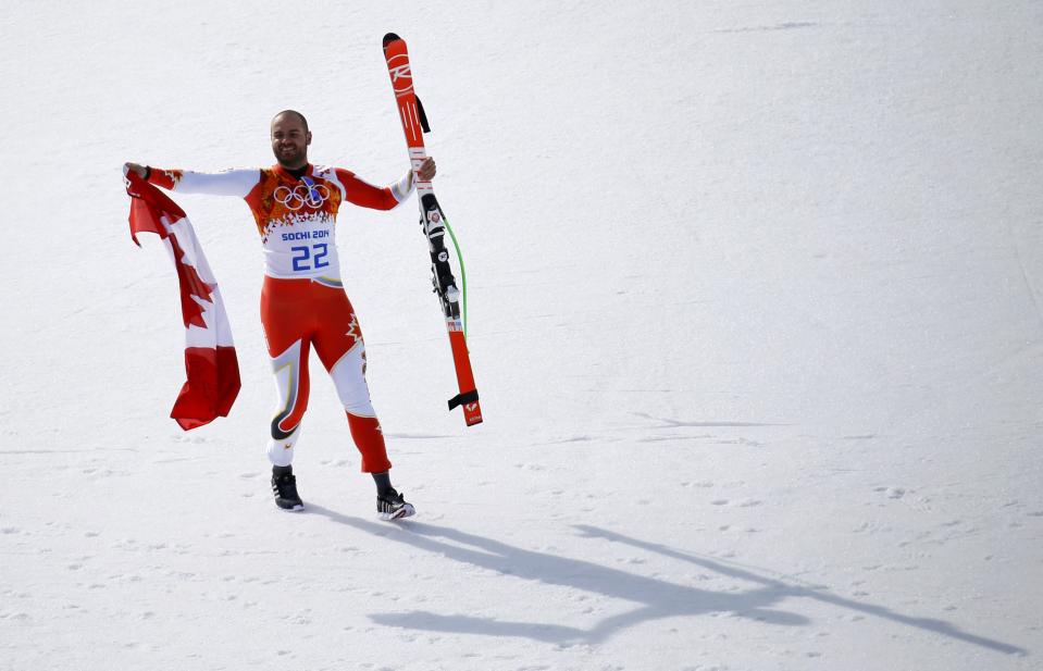 Third-placed Canada's Jan Hudec waves his flag after the men's alpine skiing Super-G competition at the 2014 Sochi Winter Olympics at the Rosa Khutor Alpine Center February 16, 2014. REUTERS/Kai Pfaffenbach (RUSSIA - Tags: OLYMPICS SPORT SKIING)