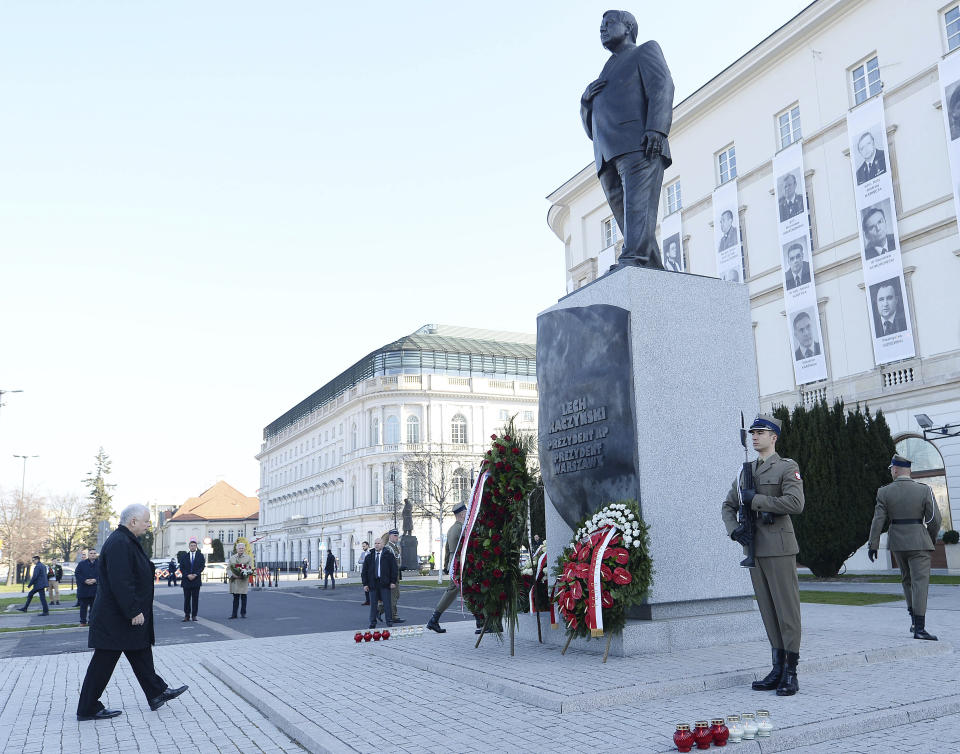 The head of Poland's ruling conservative party, Jaroslaw Kaczynski, lays down a wreath during a scaled-down observance in memory of his twin brother, the late President Lech Kaczynski, and 95 other prominent Poles who were killed in a plane crash in Russia 10 years ago, at the late president's monument in Warsaw, Poland, Friday, April 10, 2020. The observances were scaled down to just a few people and no crowd, under social distancing regulations against the spread of the coronavirus. The new coronavirus causes mild or moderate symptoms for most people, but for some, especially older adults and people with existing health problems, it can cause more severe illness or death.(AP Photo/Czarek Sokolowski)