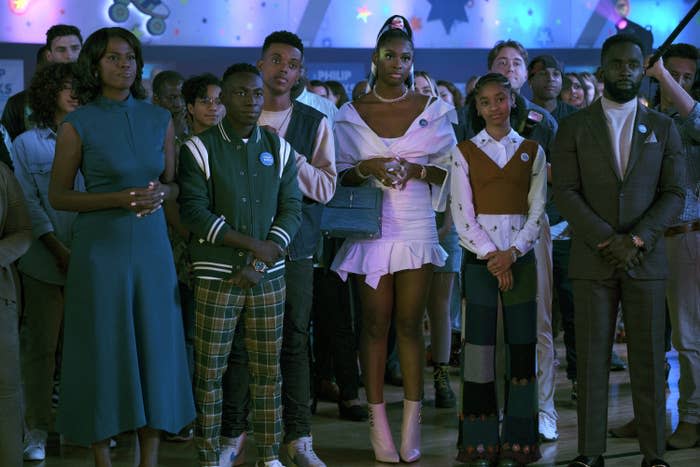 A scene from the Bel-Air reboot with kids and adults standing together and looking serious