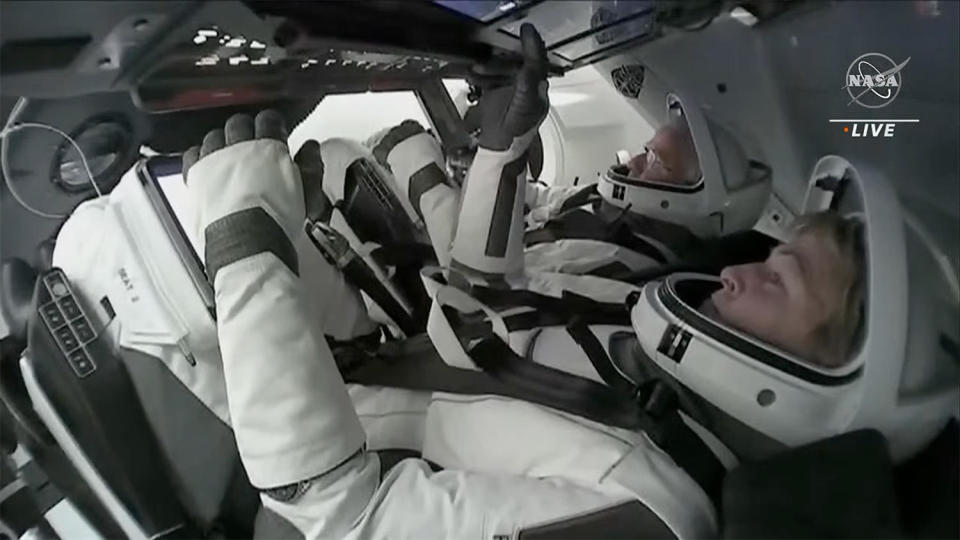 Crew Dragon commander Peggy Whitson, foreground, and pilot John Shoffner monitored touchscreen control panels as they worked through the final moments of their space station departure timeline. Out of view to left and right were Saudi astronauts Ali Alqarni and Rayyanah Barnawi. / Credit: SpaceX