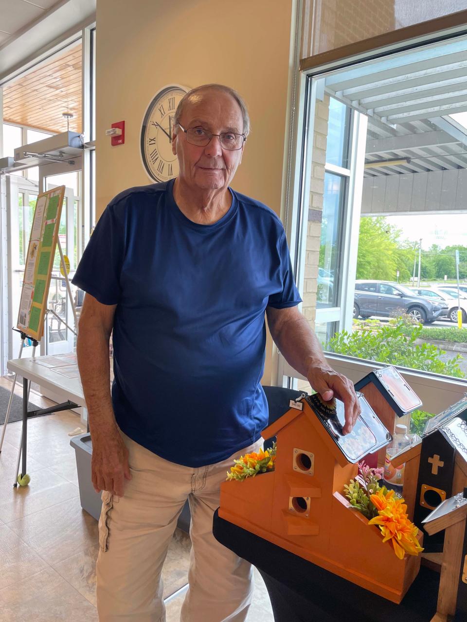 Tony Luttrell offers birdhouses made with wood and clever license plate roofs at the annual Spring Craft Show held at Karns Senior Center April 30, 2024.