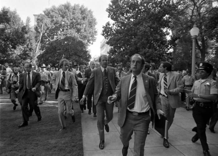 Secret Service agents rush President Gerald R. Ford towards the California State Capitol following an attempt on the president's life by Lynette "Squeaky" Fromme -- a disciple of Charles Manson -- on September 5, 1975, in Sacramento, Calif. File Photo courtesy Gerald R. Ford Library