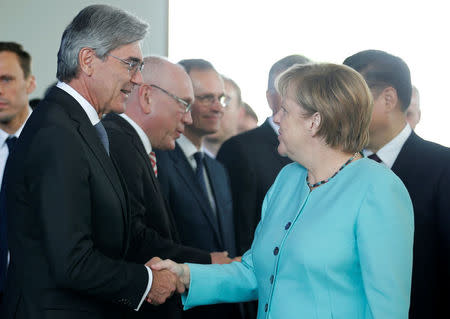 Siemens President and CEO Joe Kaeser shakes hands with German Chancellor Angela Merkel during a contract signing ceremony at the Chancellery in Berlin, Germany, July 5, 2017. REUTERS/Axel Schmidt