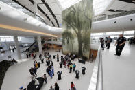 CORRECTS CITY TO KENNER, NOT BATON ROUGE- People have refreshments during festivities for the opening of the newly built main terminal of the Louis Armstrong New Orleans International Airport in Kenner, La., Tuesday, Nov. 5, 2019. (AP Photo/Gerald Herbert)