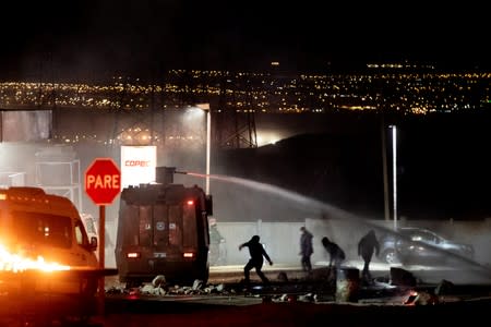 Demonstrators clash with riot police during a union strike of Chuquicamata copper mine, one of the world's largest, in Calama