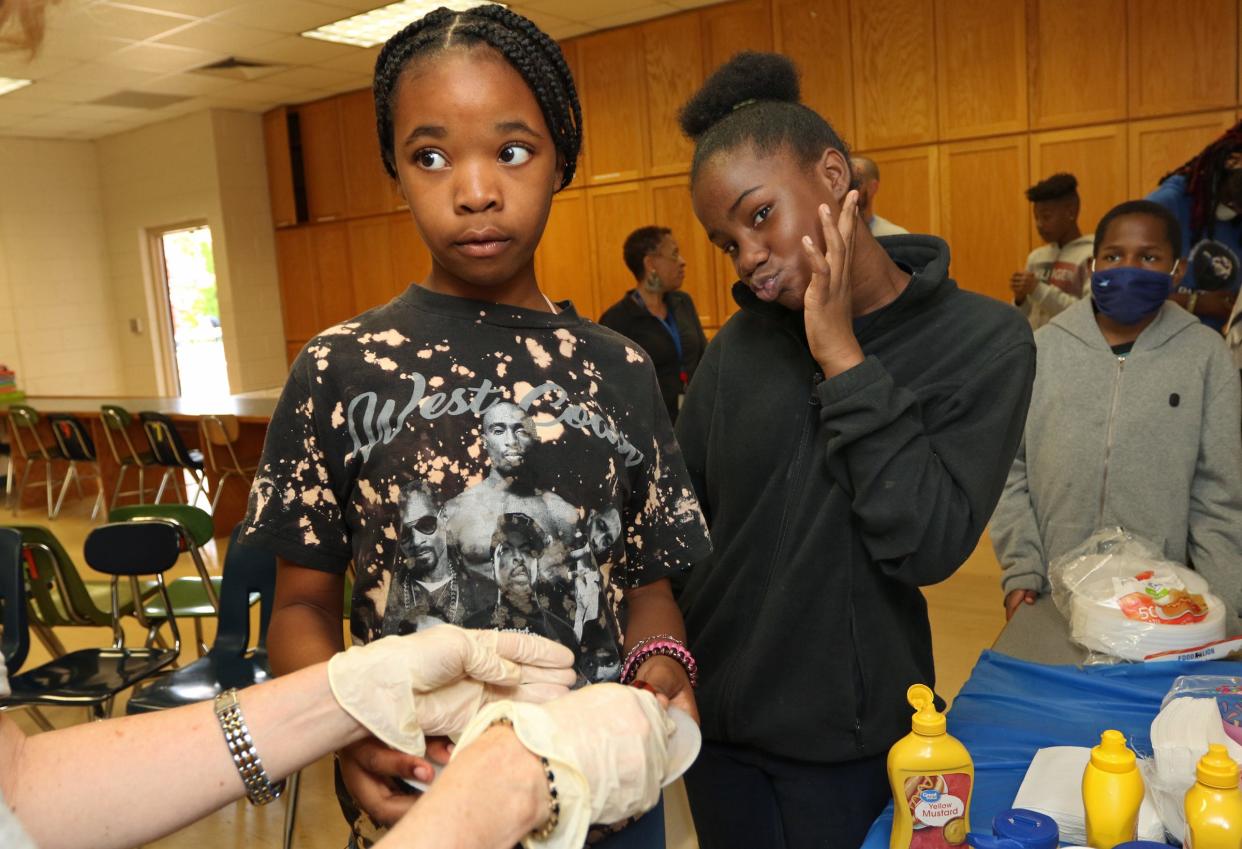 Sixth grade teacher Amy Allen serves a hot dog to student Kalasia Boykins during a reading celebration held Friday, May 13, 2022, at Shelby Intermediate School on South Post Road.