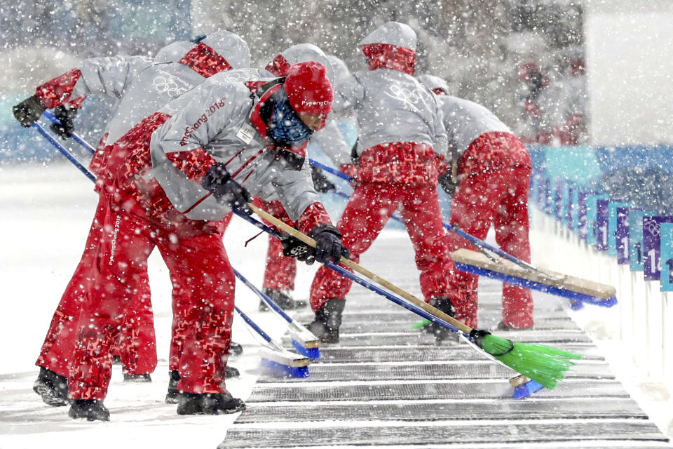 <p>Course workers clear the snow off of the shooting range during the Women’s 4x6km Biathlon Relay at the 2018 Winter Olympics in PyeongChang, South Korea, Feb. 22, 2018.<br> (AP Photo/Andrew Medichini) </p>