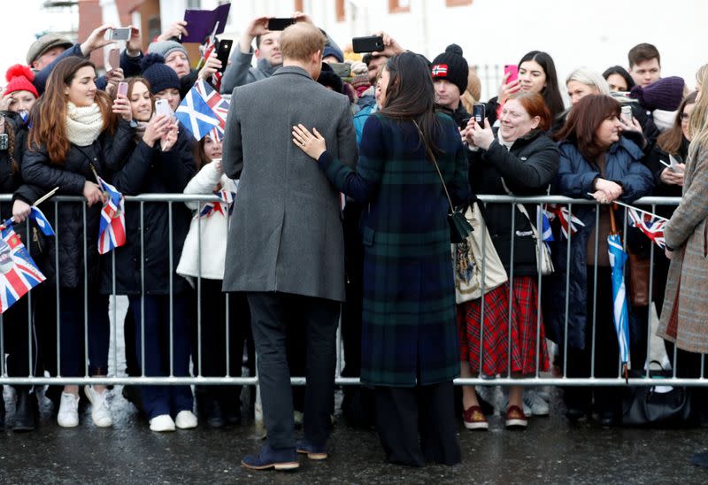 FILE PHOTO: Meghan Markle, and Britain's Prince Harry, meet members of the crowd as they arrive for a visit to Edinburgh