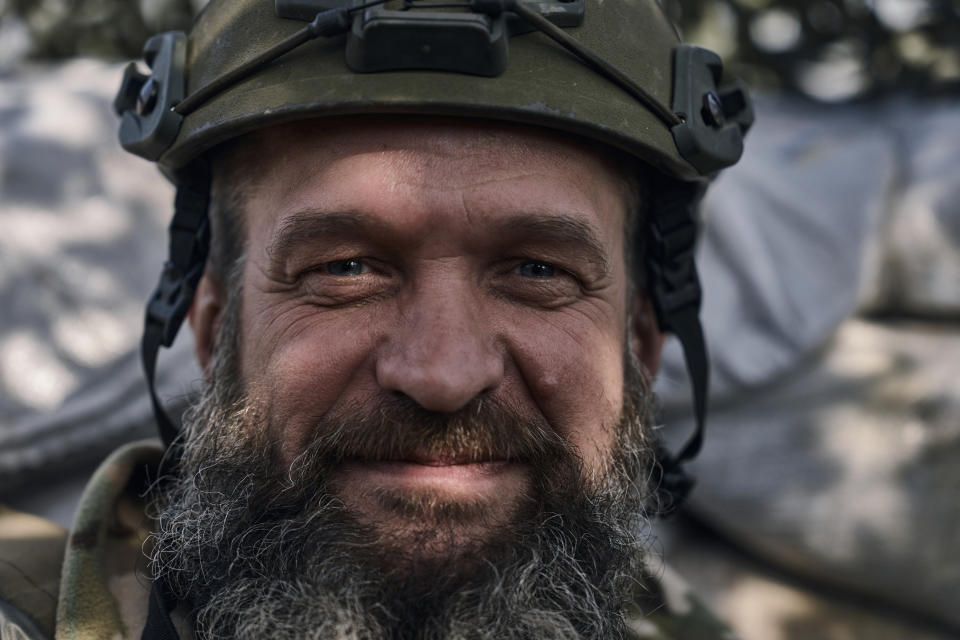 A Ukrainian soldier of the 28th brigade smiles on the frontline during a battle with Russian troops near Bakhmut, Donetsk region, Ukraine, Friday, March 24, 2023. (AP Photo/Libkos)