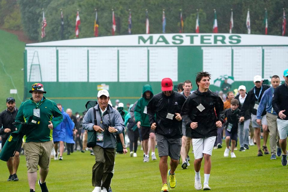 Patrons enter the course by the Masters scoreboard.