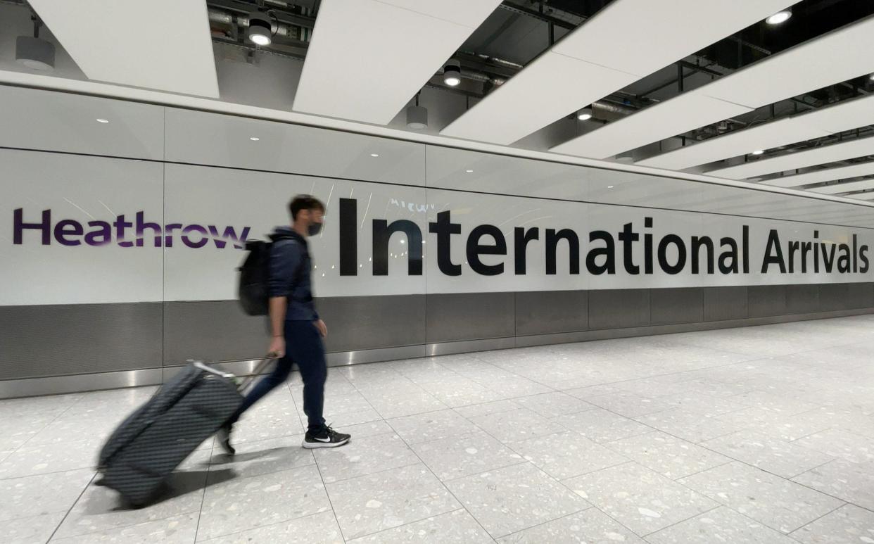 International passengers walk through the arrivals area at Terminal 5 at Heathrow Airport on November 26 - Leon Neal 