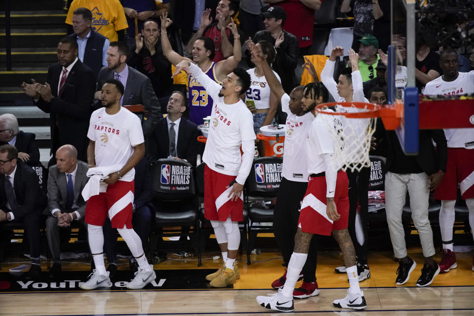 Toronto Raptors players celebrate from the bench during the second half of Game 4 of basketball's NBA Finals against the Golden State Warriors in Oakland, Calif., Friday, June 7, 2019. (AP Photo/Tony Avelar)
