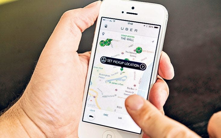 The Uber app is a popular tool with Londoners priced out of black cabs - Alamy