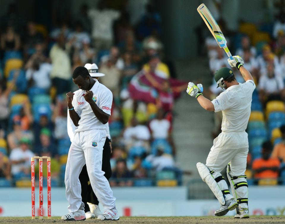 West Indies bowler Kemar Roach (L) celebrates dismissing Australian batsman Matthew Wade (R) during the final day of the first-of-three Test matches between Australia and West Indies at the Kensington Oval stadium in Bridgetown on April 11, 2012. Australia is chasing a target of 192 runs to win the match. AFP PHOTO/Jewel Samad (Photo credit should read JEWEL SAMAD/AFP/Getty Images)