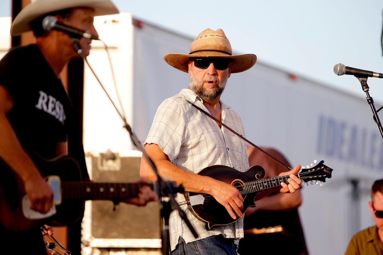 John Cooper performs with the Red Dirt Rangers during the Woody Guthrie Folk Festival in Okemah, Okla., Thursday, July 12, 2018.