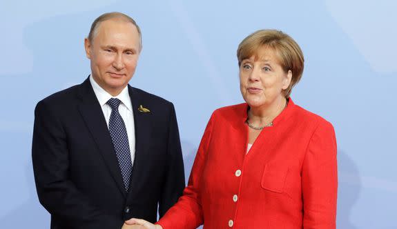 Russian President Vladimir Putin and German Chancellor Angela Merkel shake hands at the G20 summit.