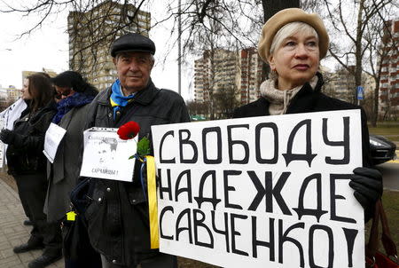 People take part in a protest in front of Russian embassy demanding the liberation of Ukrainian army pilot Nadezhda Savchenko by Russia, in Minsk, Belarus March 9, 2016. The sign reads :"Freedom for Nadezhda Savchenko". REUTERS/Vasily Fedosenko