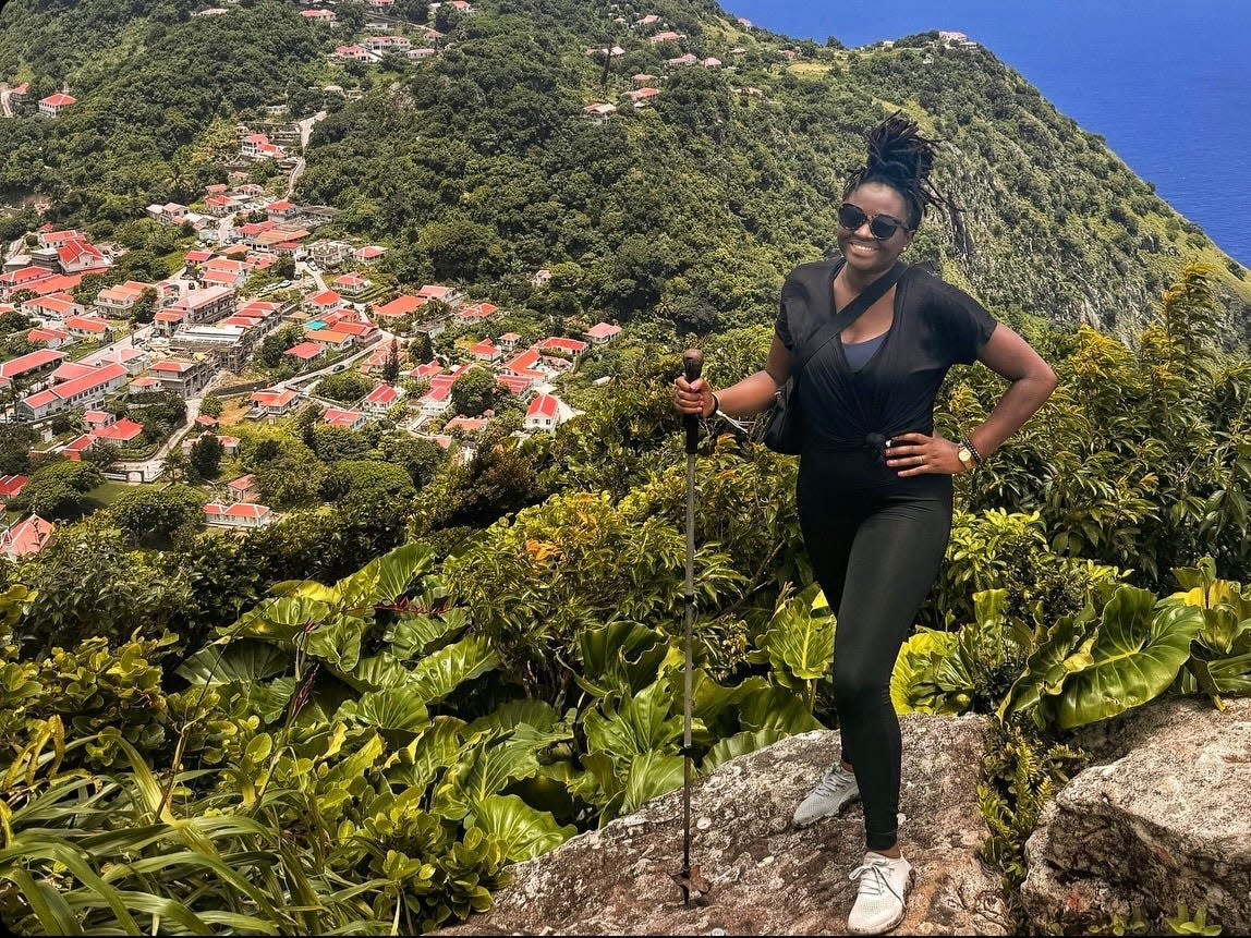 Mariette wearing watershoes, leggings, and a belt bag on a hike in the Caribbean Island of Saba.