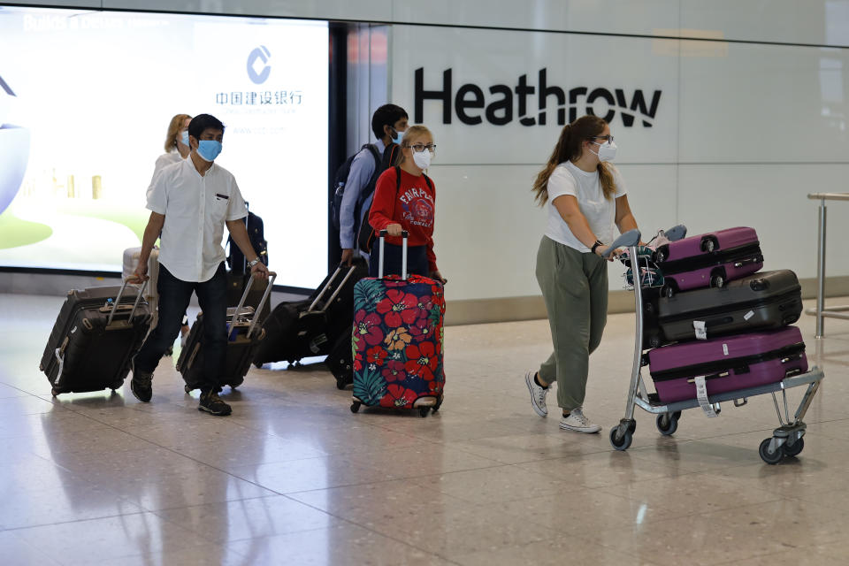 Passengers wearing PPE (personal protective equipment) arrive at Terminal 2 of Heathrow airport, west London on May 22, 2020. (Photo by Tolga Akmen / AFP) (Photo by TOLGA AKMEN/AFP via Getty Images)