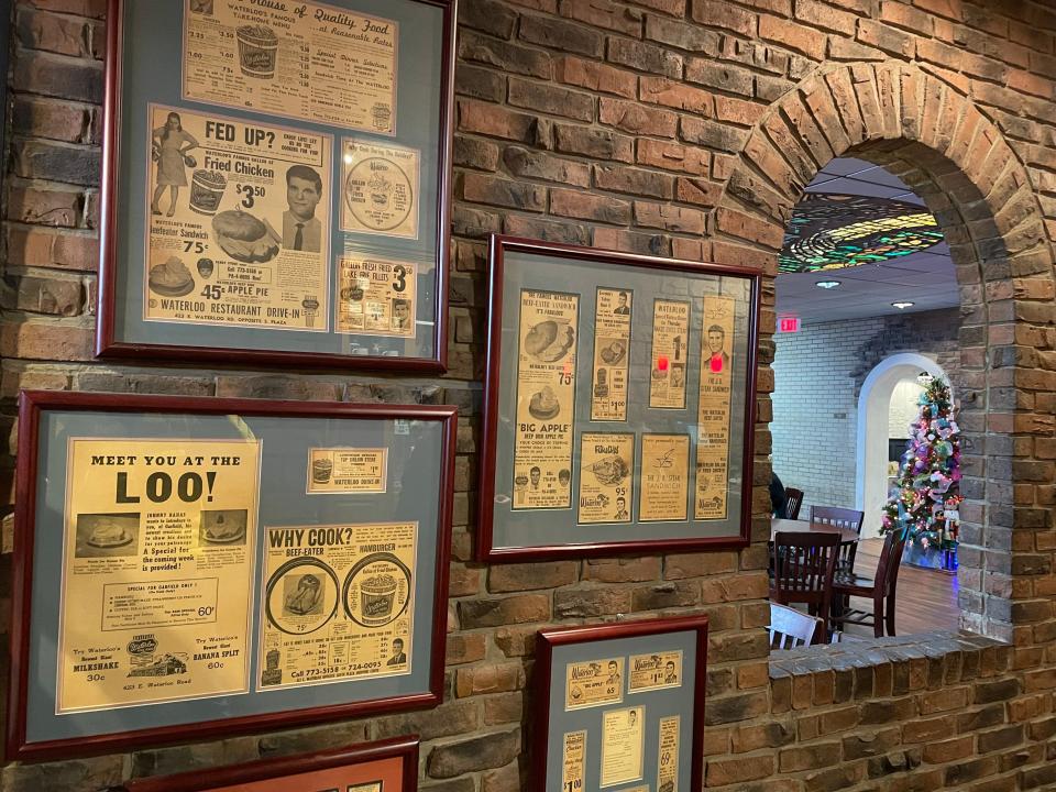 The waiting area of the Waterloo Restaurant in Akron features old newspaper ads and menus.