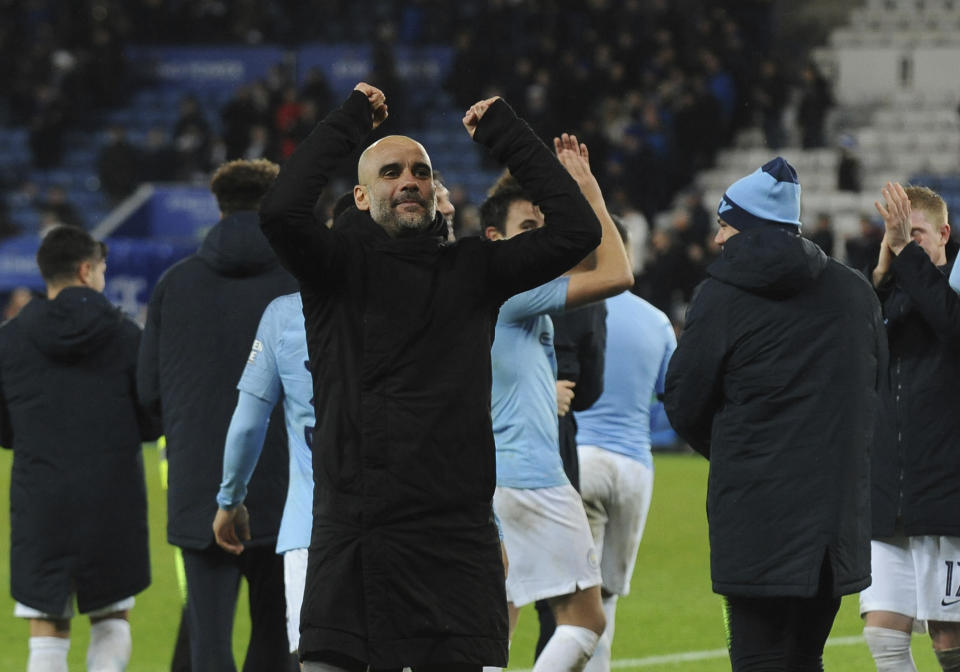 Manchester City's manager Pep Guardiola celebrates towards his teams fans after winning their English League Cup quarterfinal soccer match at the King Power stadium in Leicester, England, Tuesday, Dec.18, 2018. Manchester City won 3-1 in a penalty shoot out after the match ended in a 1-1 draw in normal time.(AP Photo/Rui Vieira)