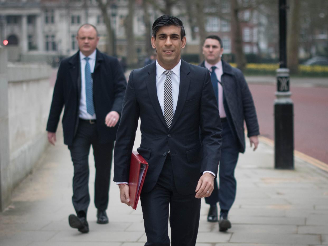 Chancellor of the Exchequer, Rishi Sunak, walks from the Treasury to No 11 Downing Street, London, the day before delivering his budget (PA)