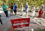 People arrive to cast their ballot for 2016 elections at a polling station as early voting begins in North Carolina, in Carrboro, North Carolina, U.S., October 20, 2016. REUTERS/Jonathan Drake