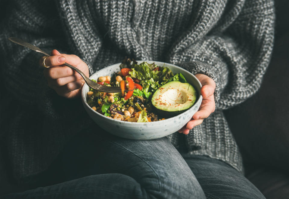 A woman eating a salad.