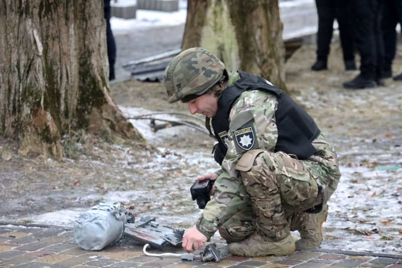 Law enforcement officers, explosive experts and rescuers work work at the site where Russian missile debris fell. --/Ukrinform/dpa