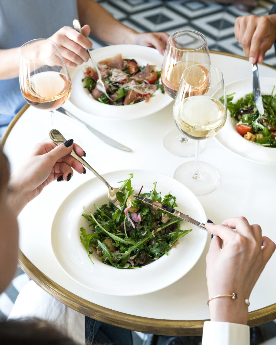 Salads and wine glasses on a table