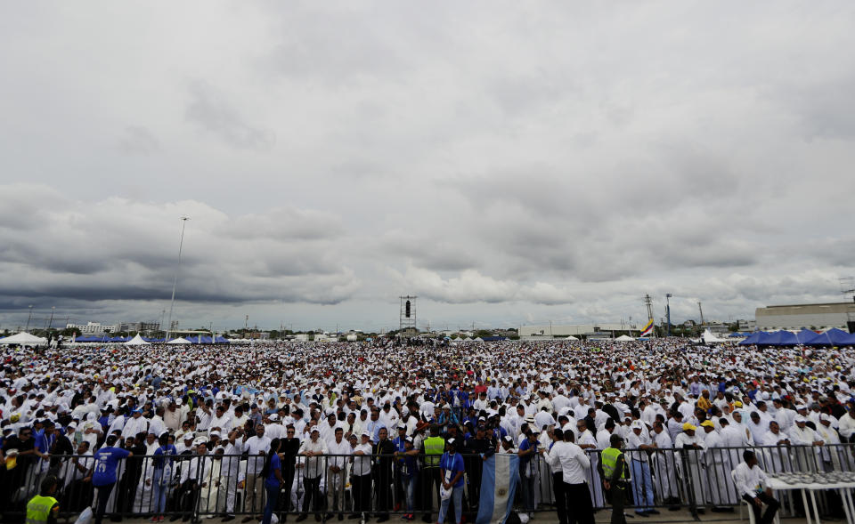 People wait for the arrival of Pope Francis to celebrate Mass in the area of Contecar harbor in Cartagena, Colombia, Sunday, Sept. 10, 2017. (AP Photo/Andrew Medichini)