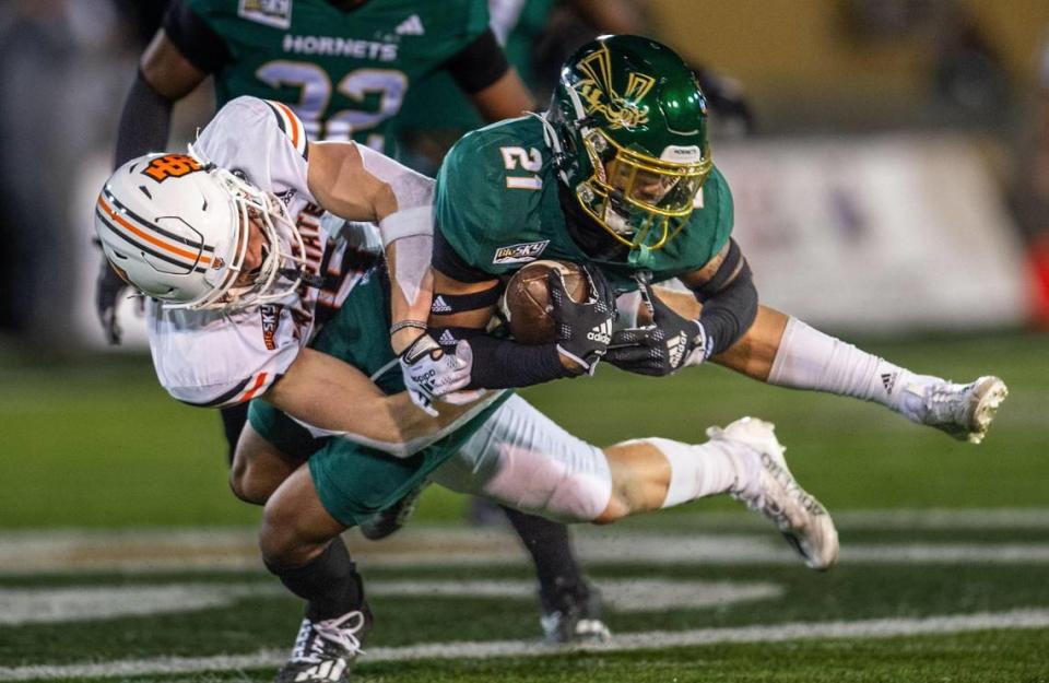 Sacramento State Hornets safety Kylen Ross (21) makes an interception against the Idaho State wide receiver Christian Fredericksen (15) in the second half at Hornet Stadium on Saturday.