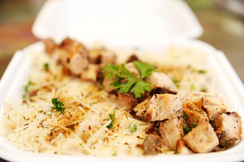 The Jerk Chicken Alfredo Pasta dish from Trap Fusion can be seen on the ordering counter on Wednesday, December 13, 2023 at 670 N Germantown Parkway in Cordova, Tenn.