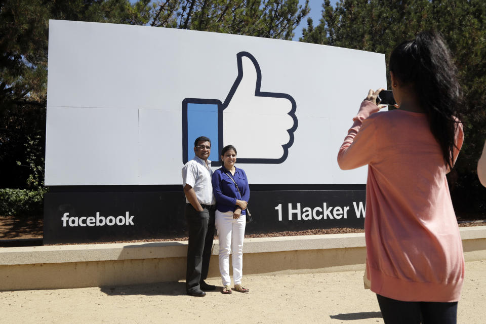 FILE - In this Aug. 31, 2016, file photo, visitors take photos in front of the Facebook logo outside of the company's headquarters in Menlo Park, Calif. Facebook reports earnings Wednesday, April 24, 2019. (AP Photo/Marcio Jose Sanchez, File)