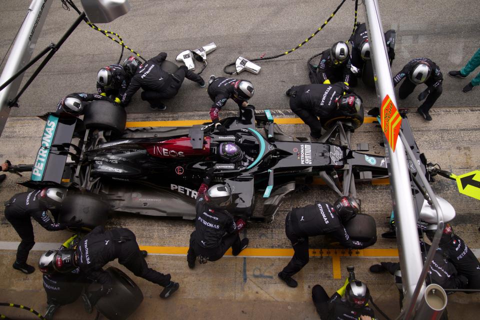 Somehow, 14 crew members can stay out of each other's way to get an F1 car out of the pits in less than three seconds.