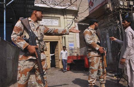 Paramilitary soldiers stand guard outside a Hindu temple that was attacked on Saturday night, in Larkana, southern Pakistan's Sindh province, March 16, 2014. REUTERS/Faheem Soormro