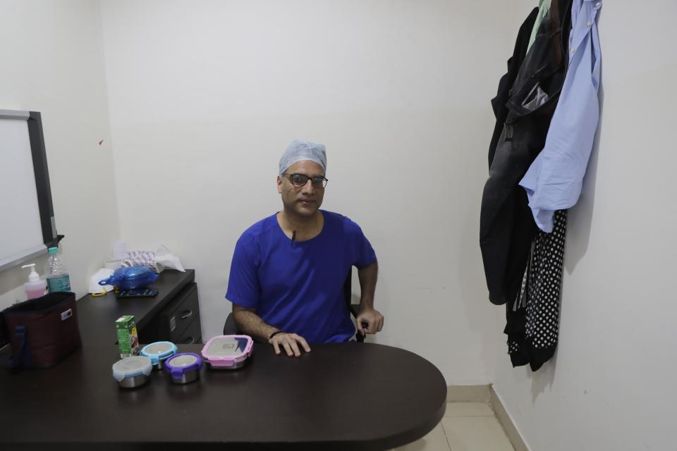 Dr. Kedar Toraskar, head of critical care, center, sits down for a quick lunch in the doctors room at the Mumbai Central Wockhardt Hospital in Mumbai, India, June 4, 2021. The recent coronavirus surge in India affected young people on a scale his team of critical care doctors hadn’t previously seen. Toraskar and his team of ICU doctors are still drained from the incredibly challenging last few months. (AP Photo/Rajanish Kakade)