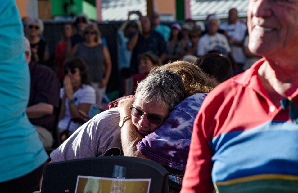 People embrace at the 1 year anniversary of Hurricane Ian on Fort Myers Beach on Thursday, Sept. 28, 2023.