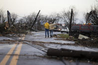Residents walk through downed utility lines and trees to survey damage caused by one of several tornadoes that tore through the state overnight on March 3, 2020 in Cookeville, Tennessee. At least 19 people were killed and scores more injured in storms across the state that caused severe damage in downtown Nashville. (Brett Carlsen/Getty Images)