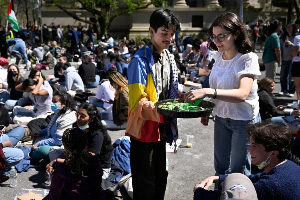 A protester grabs a piece of sushi from a man handing it out to pro-Palestinian protesters. New York Post