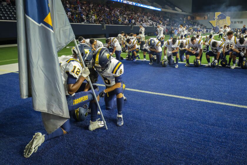 El Paso Eastwood players kneel in prayer